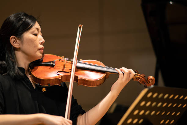 istock Violinists playing at classical music concert 1138273850
