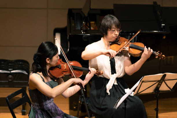 istock Musician playing violin at classical music concert 1138273873