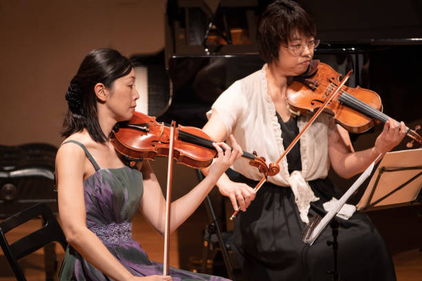 istock Female violinists playing in classical music concert 1138273909