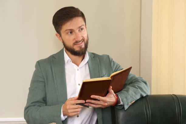 istock successful business man in the office is studying the diary 1138274753