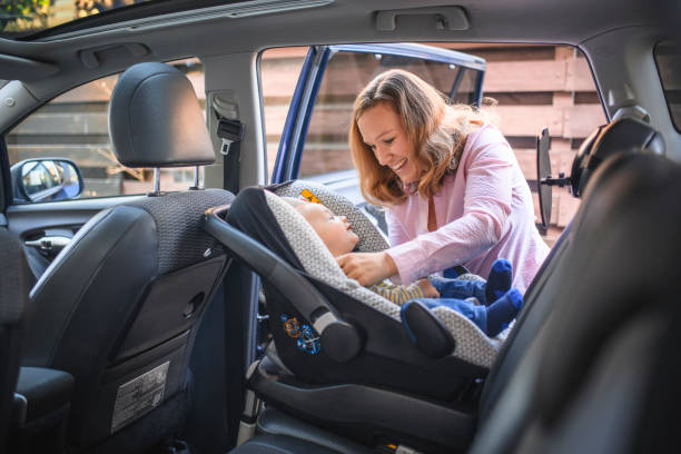 istock Mother putting her son in a car safety seat 1138274803