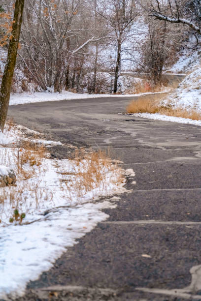 istock Weathered road on mountain with snow in winter 1138279034