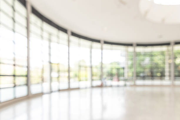 istock Blur background interior view looking out toward to empty office lobby and entrance doors and glass curtain wall 1138281267