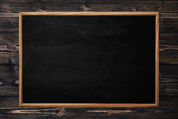 istock Abstract blackboard or chalkboard with frame on wooden background. 1138281991