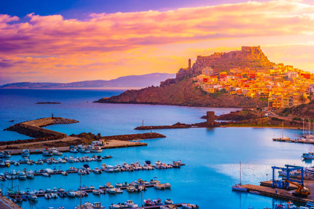 Aerial view of boats in port and city Castelsardo, one of the most beautiful city in Sardinia, Italy. Aerial view of landscape, boats, and port of city Castelsardo, one of the most beautiful city in Sardinia, Italy. castelsardo photos stock pictures, royalty-free photos & images