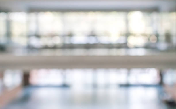 istock Business office corridor blur background interior view empty lobby hallway with glass wall white room and light bokeh 1138285646