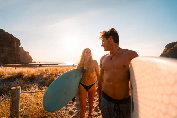 istock Gen Z Couple at beach with surfboards. 1138286428