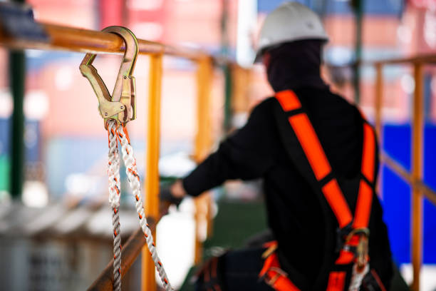 istock Construction worker wearing safety harness and safety line working on construction. 1138294783