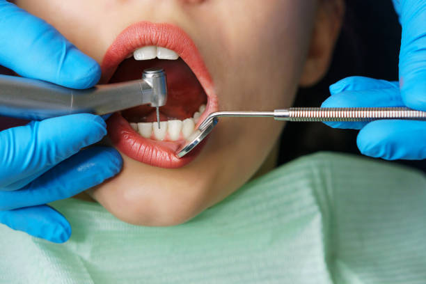 istock Dentist treats girl's teeth. 1138295418