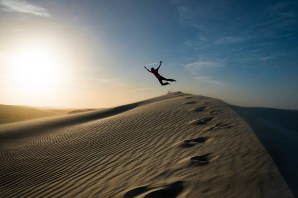 istock Man flying on sand dune white sands national monument 1138295468