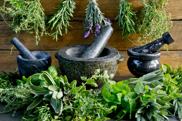 istock Fresh herbs with mortar and pestle against rustic wooden background 1138300037