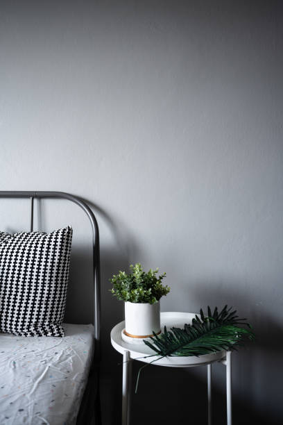 istock Bedroom Corner with artificial plants in white ceramic marble pattern paint on white metal side table in modern scandinavian style / modern minimal / cozy interior design concept 1138300203