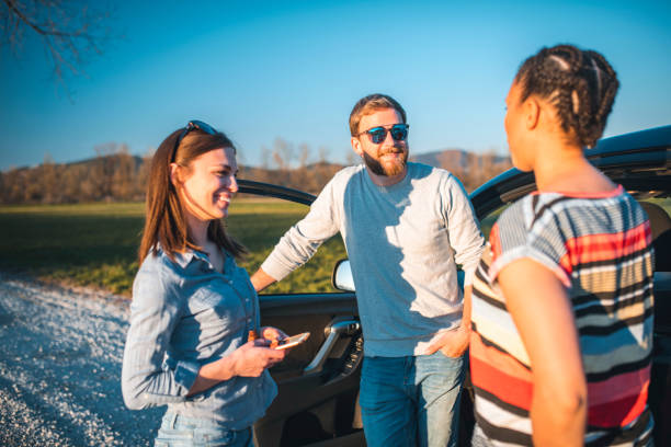 istock Friends standing next to a car and talking 1138300292