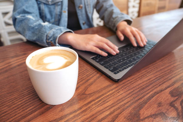 istock Closeup image of woman's hands using and typing on laptop computer keyboard with coffee cup on the table 1138301254