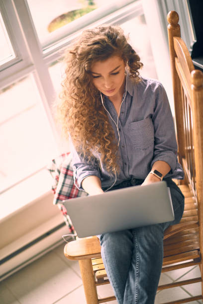 istock Young woman with laptop working from home 1138303571