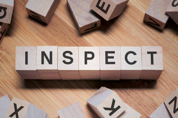 istock INSPECT Word In Wooden Cube 1138303942