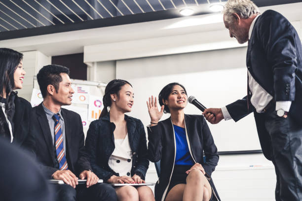 istock Senior leader speaker speaks to public people audience in training workshop or conference. Mature lecturer is CEO executive manager leading the symposium event. International business seminar concept. 1138305371