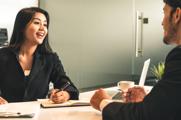 businesswoman from human resources department is interviewing businessman candidate for job application in the meeting room while considering his cv resume document. employee hiring business concept. - group of objects business human resources laptop imagens e fotografias de stock