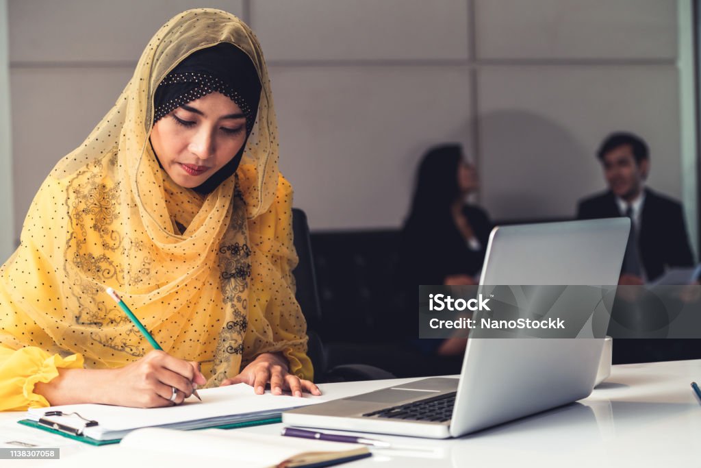 Successful Middle Eastern Muslim businesswoman working in office. International business success concept. Adult Stock Photo