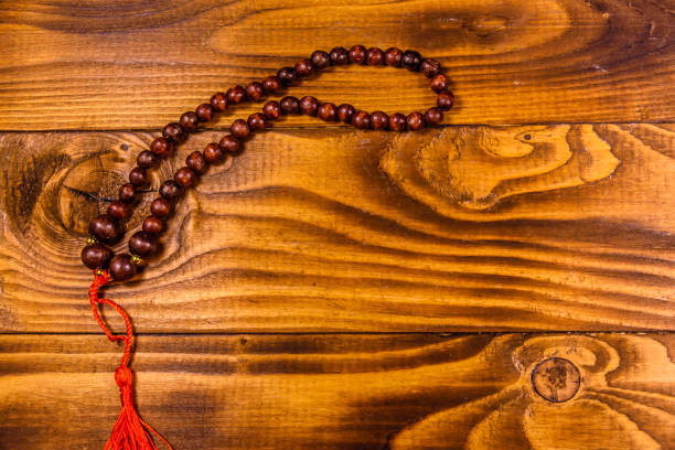 istock Brown rosary on the wooden table. Top view 1138310291