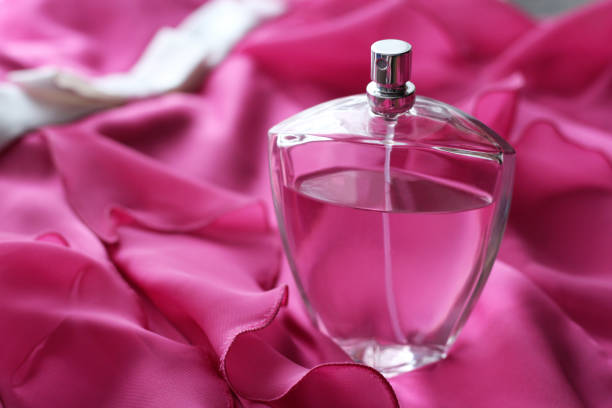 istock Bottle of perfume over pink background 1138314430