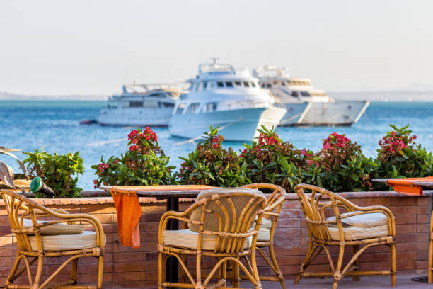 istock Open air cafe tables with sea and yachts on the background 1138314504