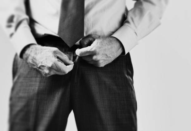 male hands zipping or unzipping trouser fly - fecho aberto imagens e fotografias de stock