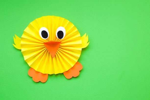istock Happy, cute, yellow chick folded and created from paper on green background. Empty place for text, quote or sayings. Top view. 1138325401