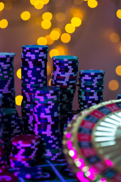 Casino theme. High contrast image of casino roulette, and poker chips stock photo