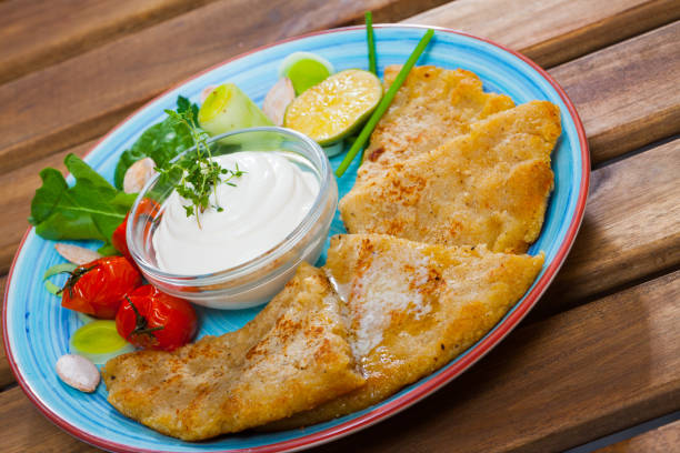 istock Cooked tasty potatoes pancakes with white sauce at white plate 1138328517