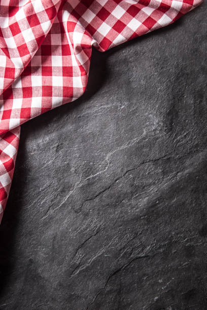istock Top of view red checkered tablecloth on black slate board 1138331180