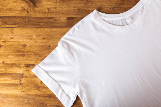 istock White t-shirt on a wooden background - 1138331213