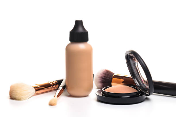 istock Liquid makeup foundation cream and  shadow, blush, powder, sculptor in a pack with make up brushes on a white background. Isolated on white. - 1138331258
