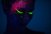 One woman painted with fluorescent make up