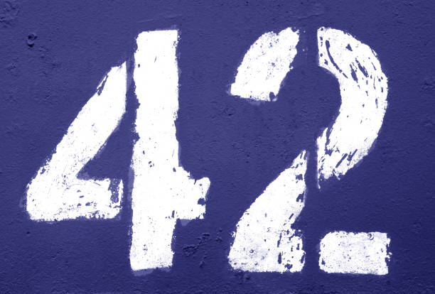 istock Number 42 in stencil on rusty metal wall in blue tone 1138331772