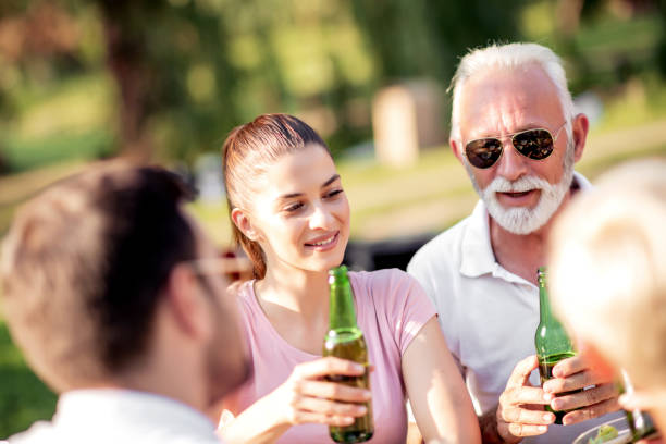 famiglia che ha un barbecue in giardino - giardino di birra foto e immagini stock