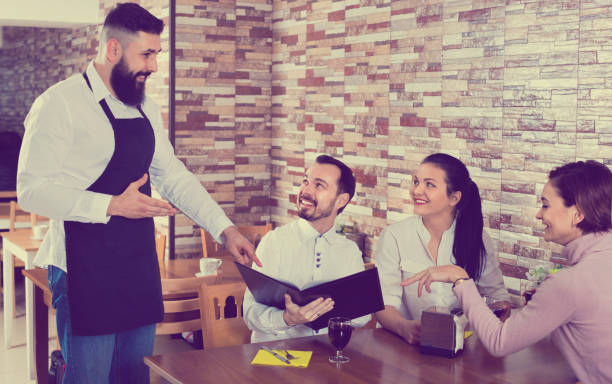 istock Waiter serving rural restaurant guests at table 1138333079