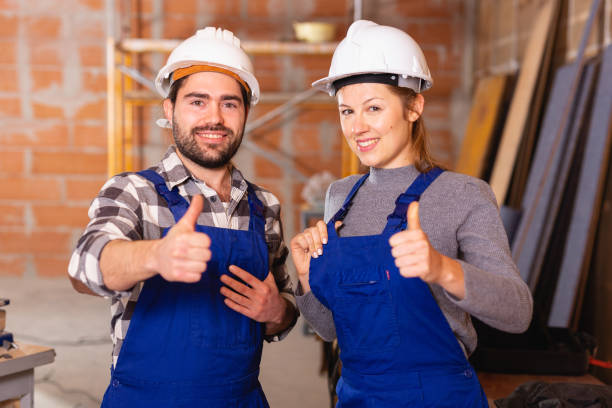istock Portrait of two successful workers in uniform inside brick cottage 1138333346
