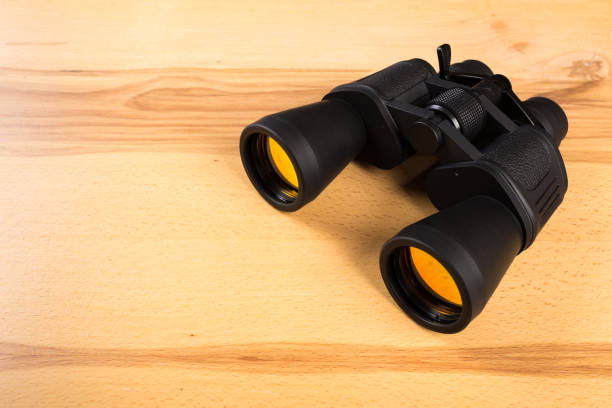 istock Dark Binoculars on the wooden table 1138334887