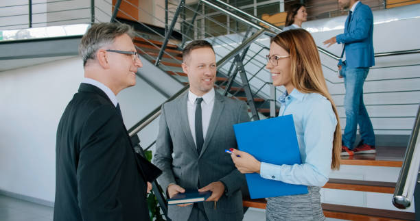istock Smiling business people chatting in the lobby 1138335125