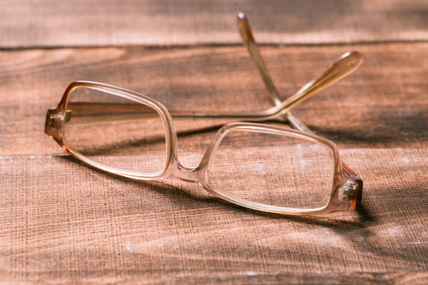 istock A pair of glasses on a wooden table 1138335211