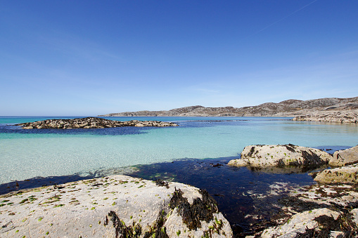 The turquoise water in the bay of Achmelvich beach in the scottish highlands.