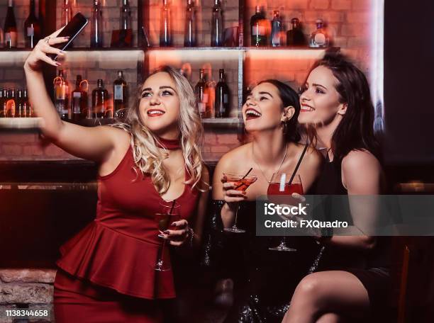 Beautiful Girl Is Drinking A Cocktail In The Bar Stock Photo - Download Image Now - Teenage Girls, Bartender, Beautiful People - iStock