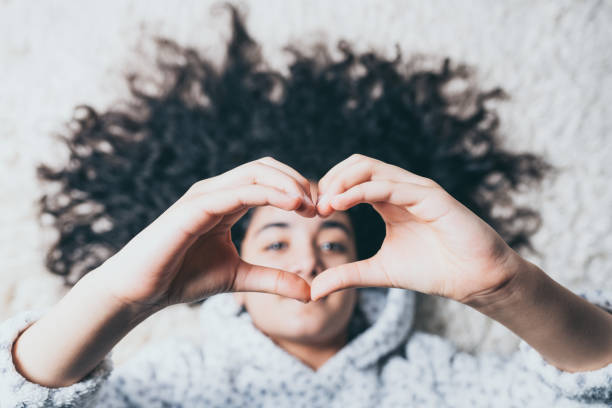istock girl making a heart with her hands 1138344731