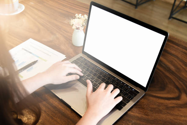 istock Business woman using laptop computer with blank screen at coffee shop. 1138344909