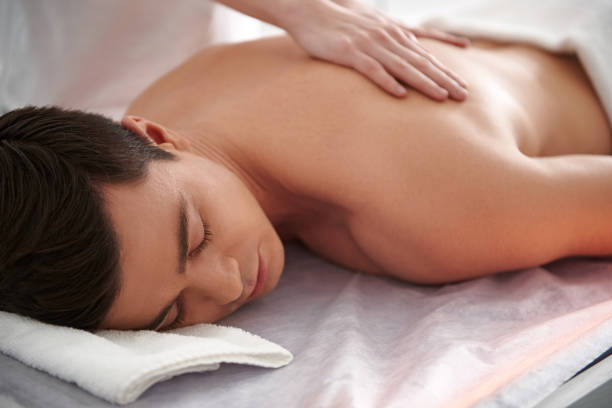 istock Young caucasian man enjoying massage in center 1138345948