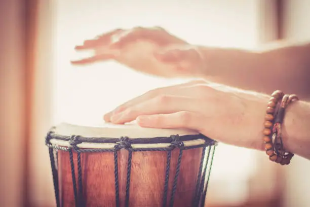 Cut out of hands which are playing the drums.