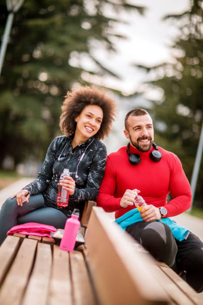 istock Two young athletes hydrating themselves while taking a break after exercising in a city park 1138348877