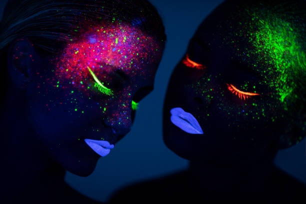 istock Two young women painted with fluorescent colors 1138352238