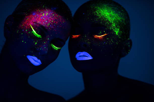 istock Two young women painted with fluorescent colors 1138352241
